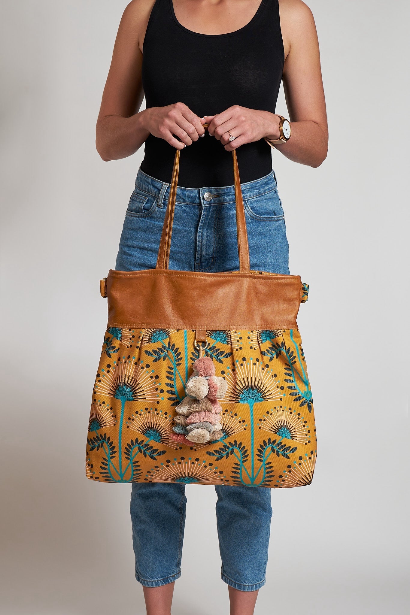 A person holding a large weekender bag