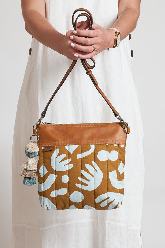 model holding a crossbody bag