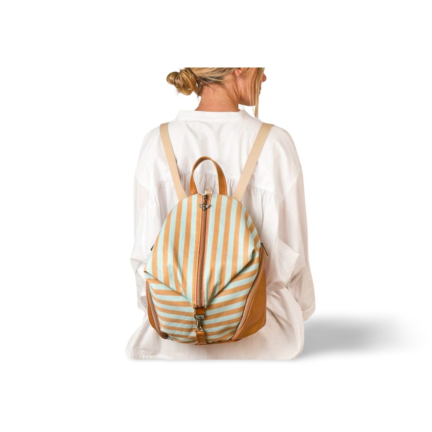 model wearing blue and tan striped backpack in canvas and leather