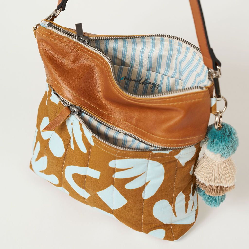 crossbody bag with a blue and tan geometric print