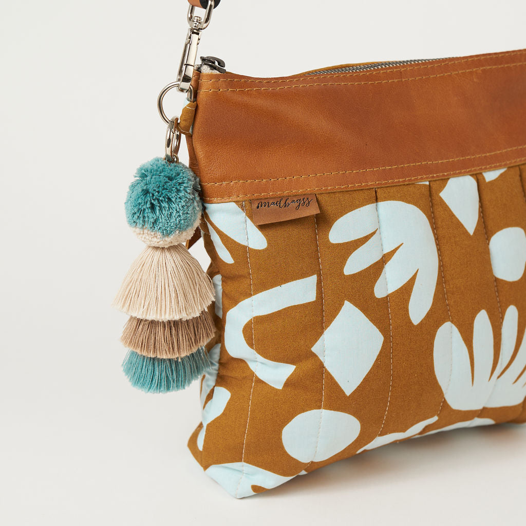 crossbody bag with a blue and tan geometric print