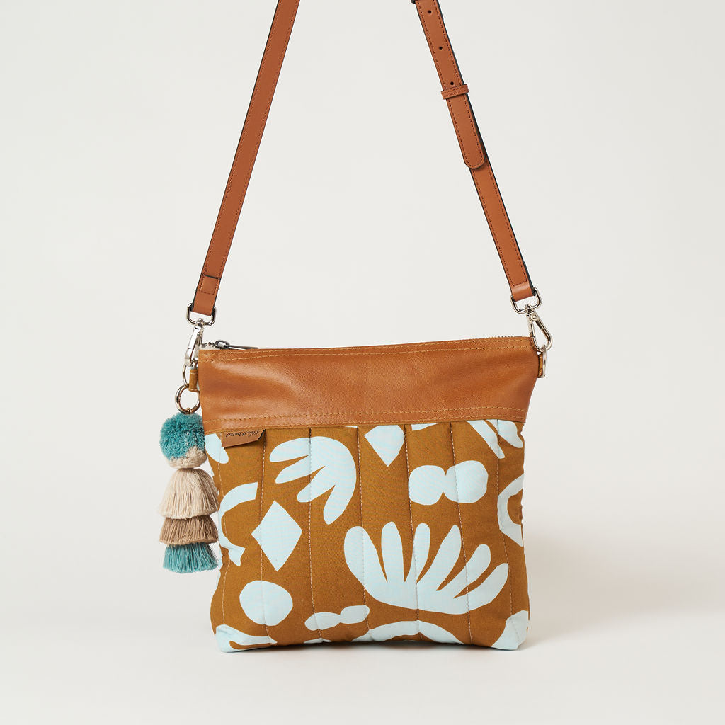 crossbody bag with a blue and tan geometric print