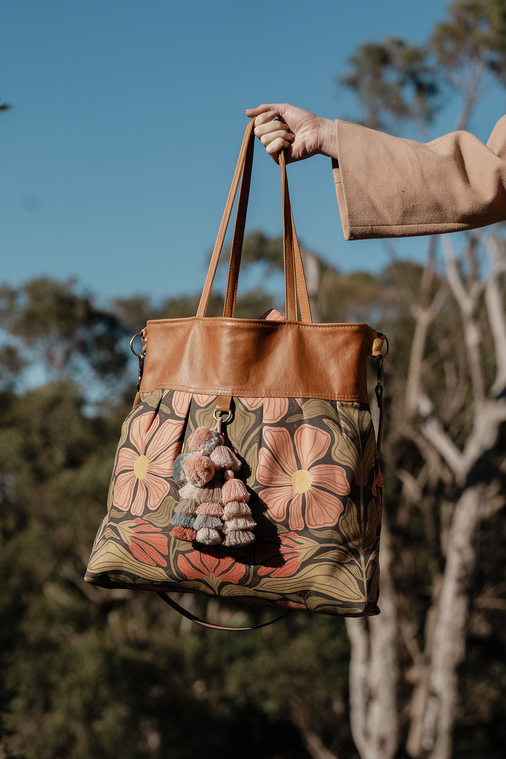 arm holding the large floral bag