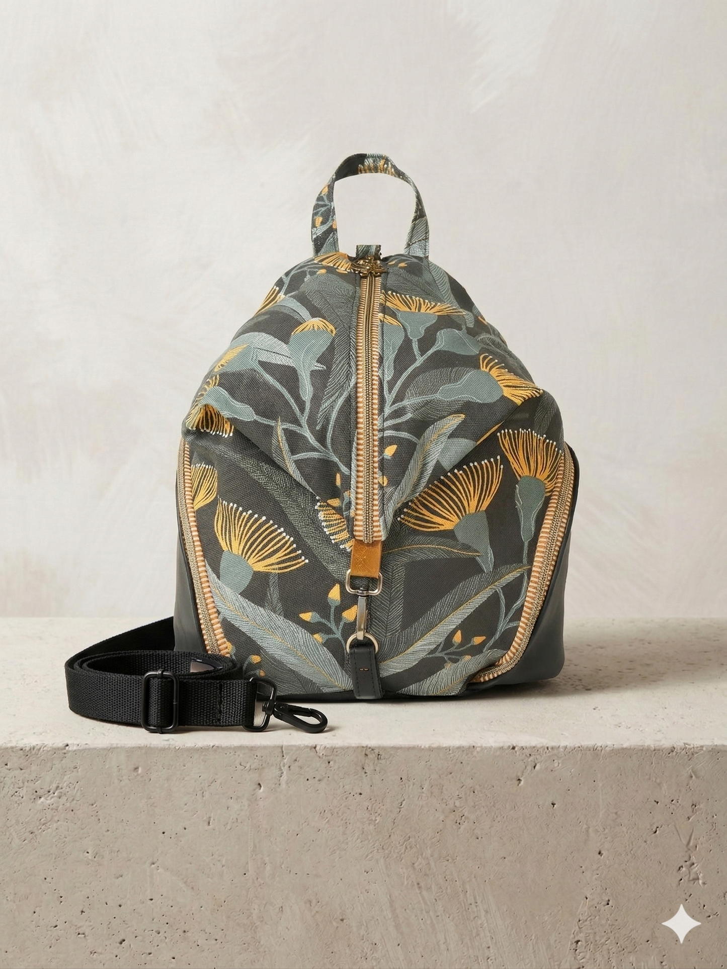 Floral-patterned backpack on a concrete surface with a neutral background