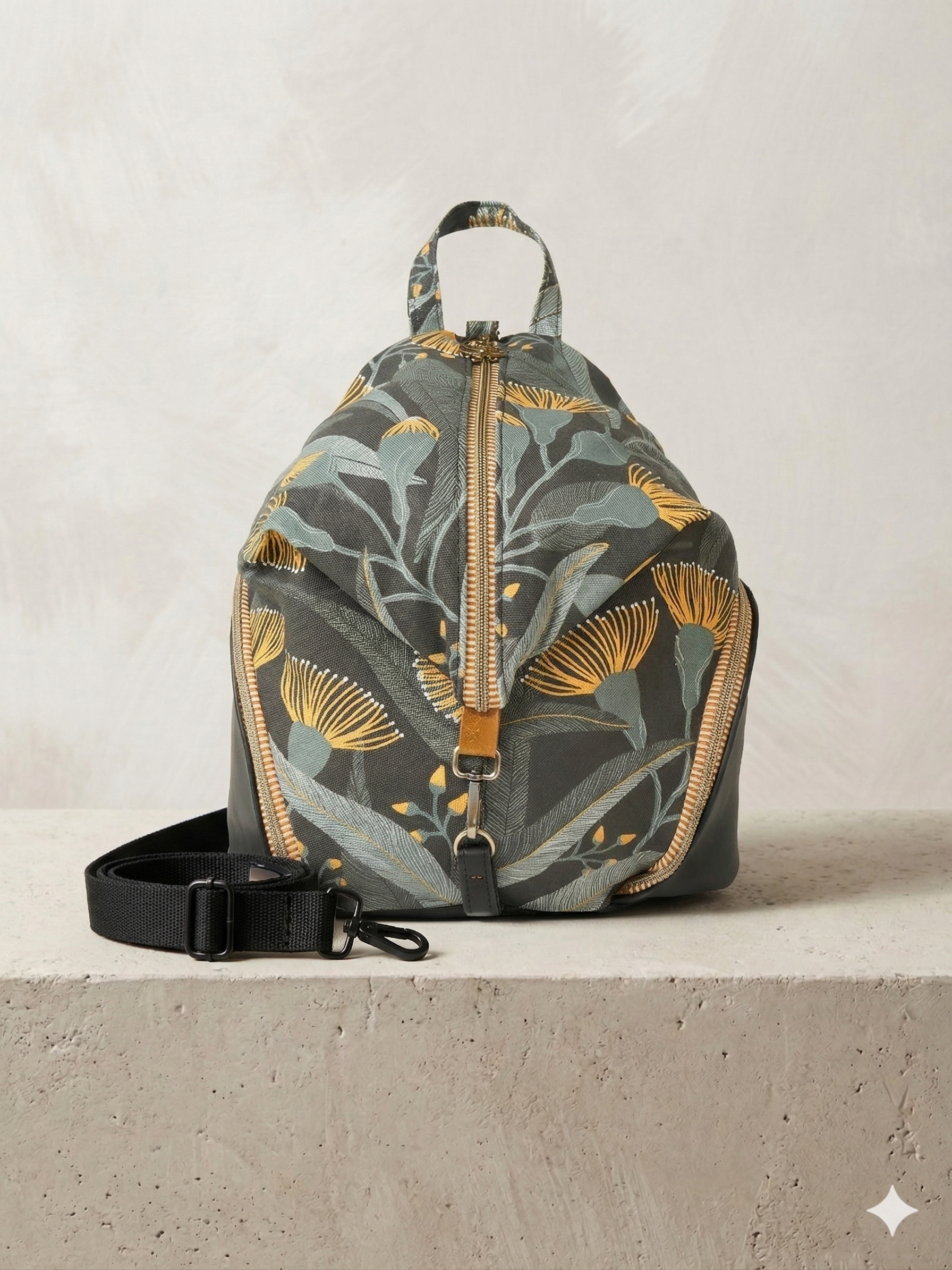 Floral-patterned backpack on a concrete surface with a neutral background